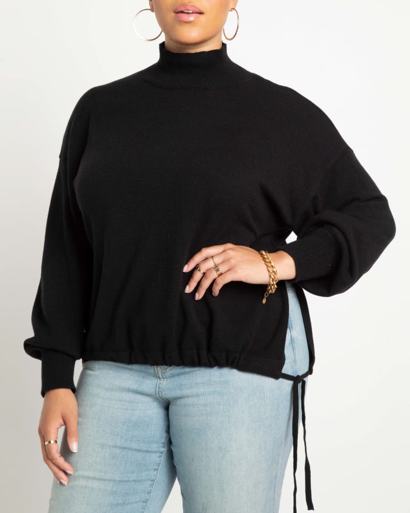 Front of a model wearing a size 14/16 Pallas Mock Neck Sweater in Totally Black by ELOQUII. | dia_product_style_image_id:242024